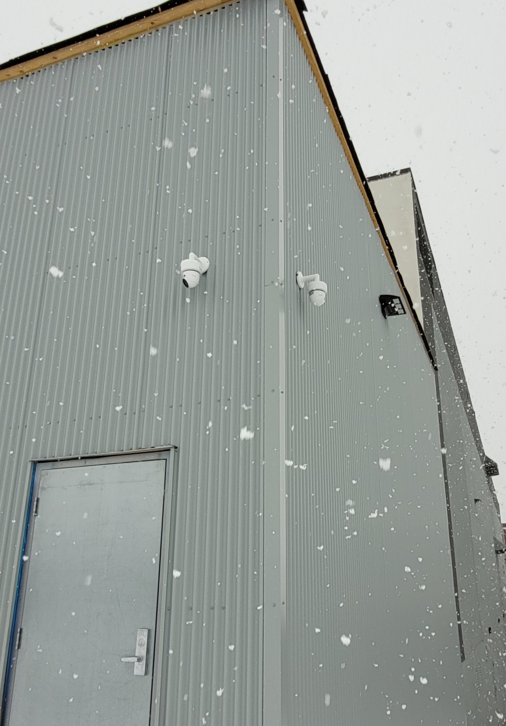 Side-mounted security cameras on building exterior